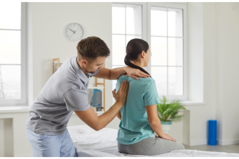 An image of an osteopath treating a patient with lower back pain
