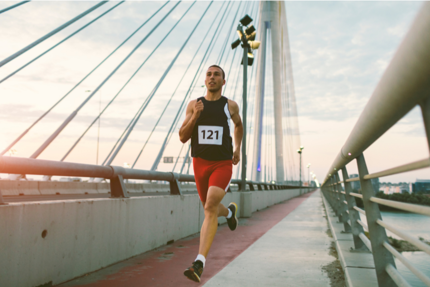 Male runner in motion through an urban environment during a morning training session